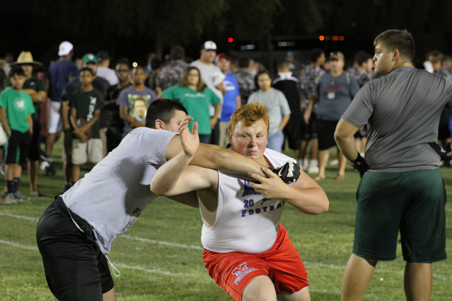 Football players tackling each other